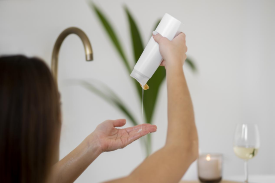 A lady is using a personal care product containing a rheology modifier.